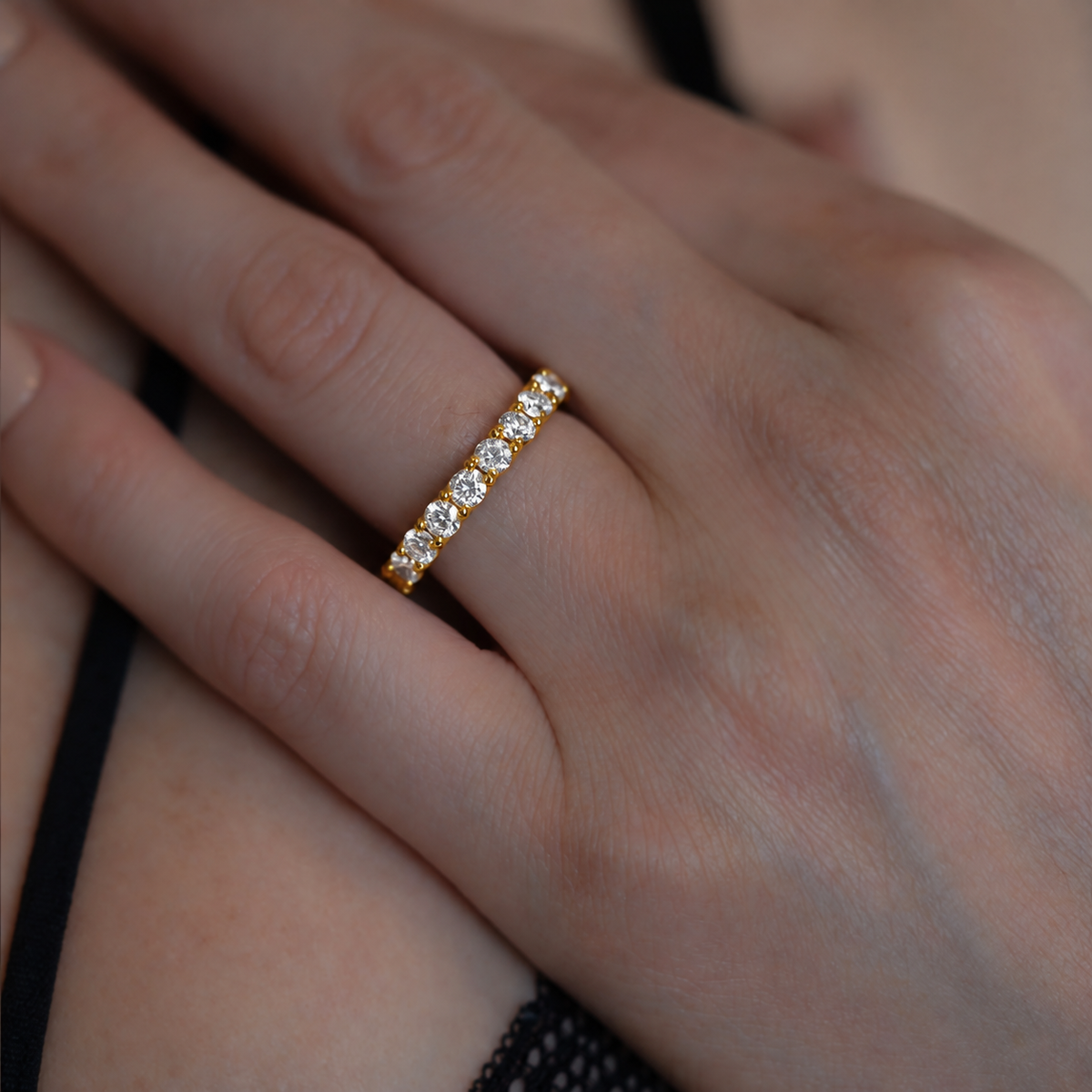 Lucy women’s diamond wedding band worn on hand, yellow gold
